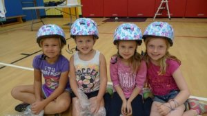 4 girls with helmets on