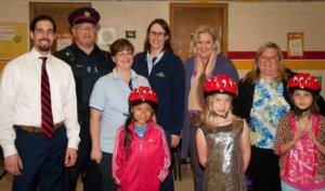 Volunteers giving helmets to kids