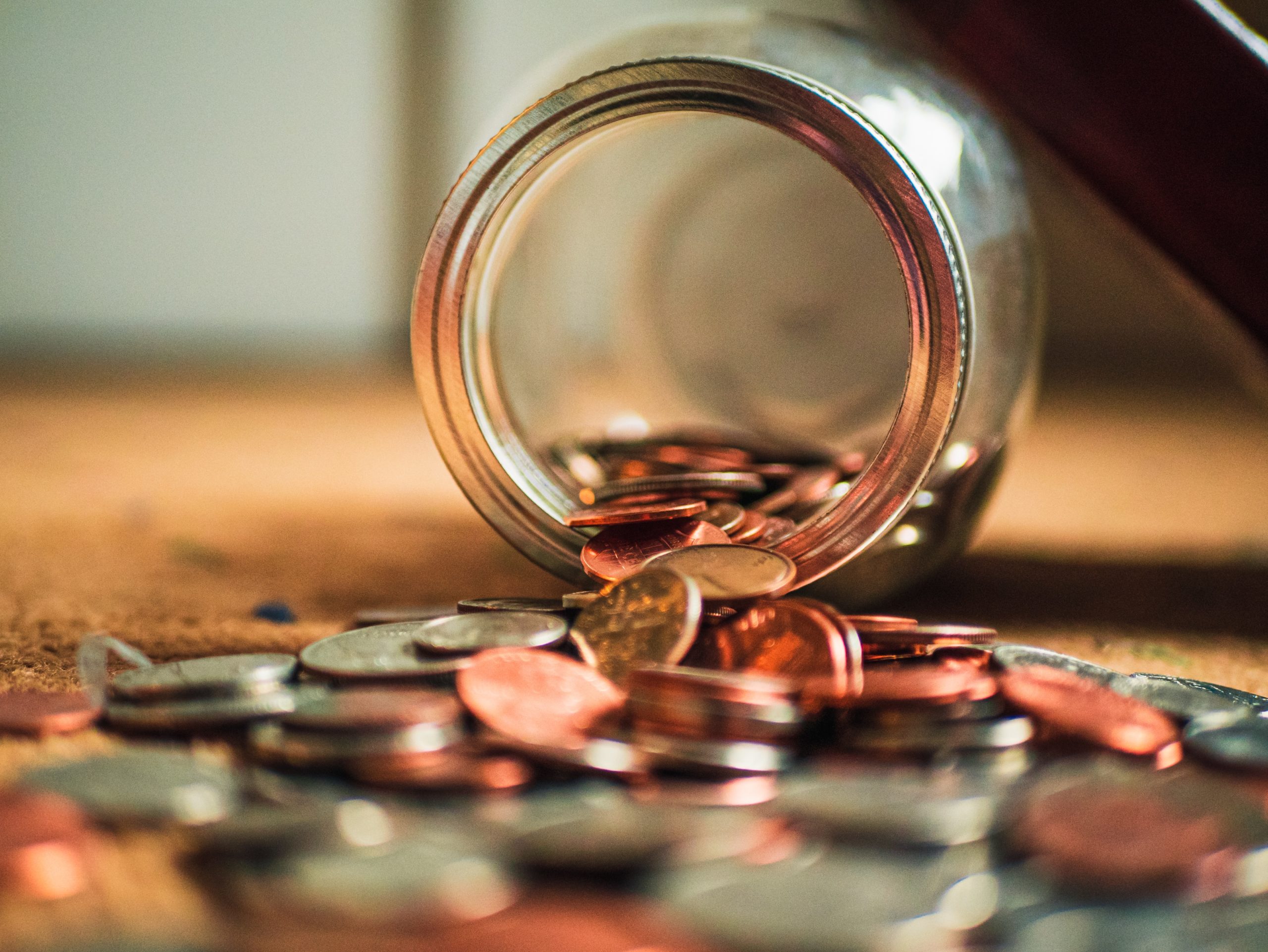 money spilling out of a jar