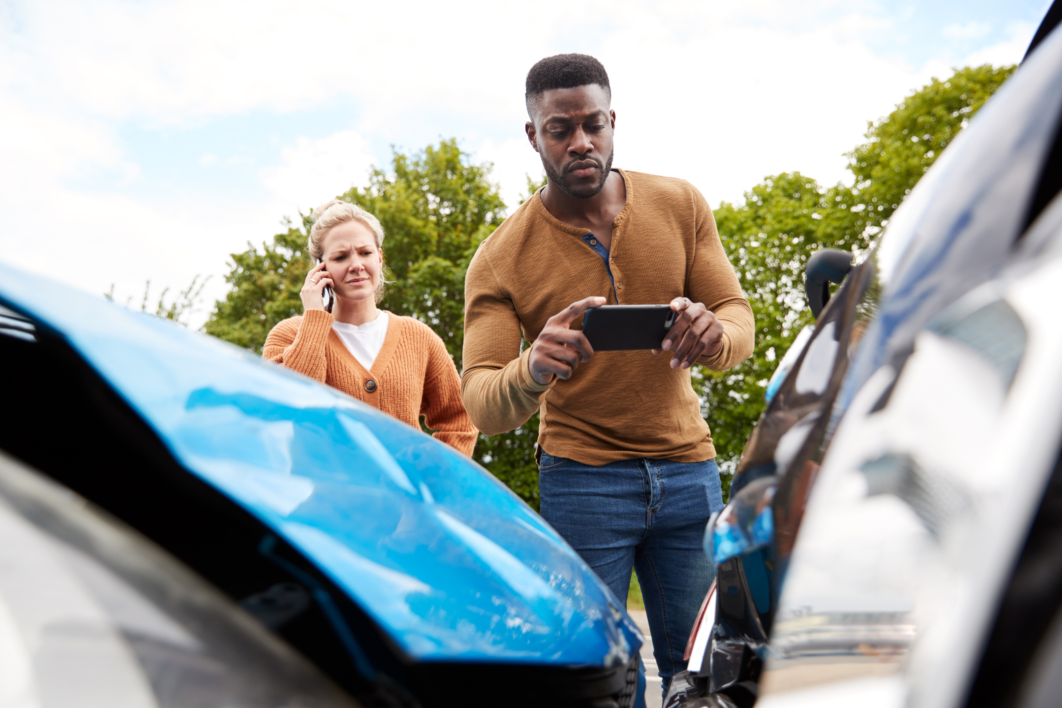 Two motorists involved in a motor vehicle collision documenting the accident.