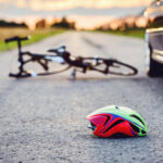 Helmet on the ground following a motor vehicle collision with a bike