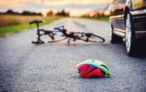 Helmet on the ground following a motor vehicle collision with a bike